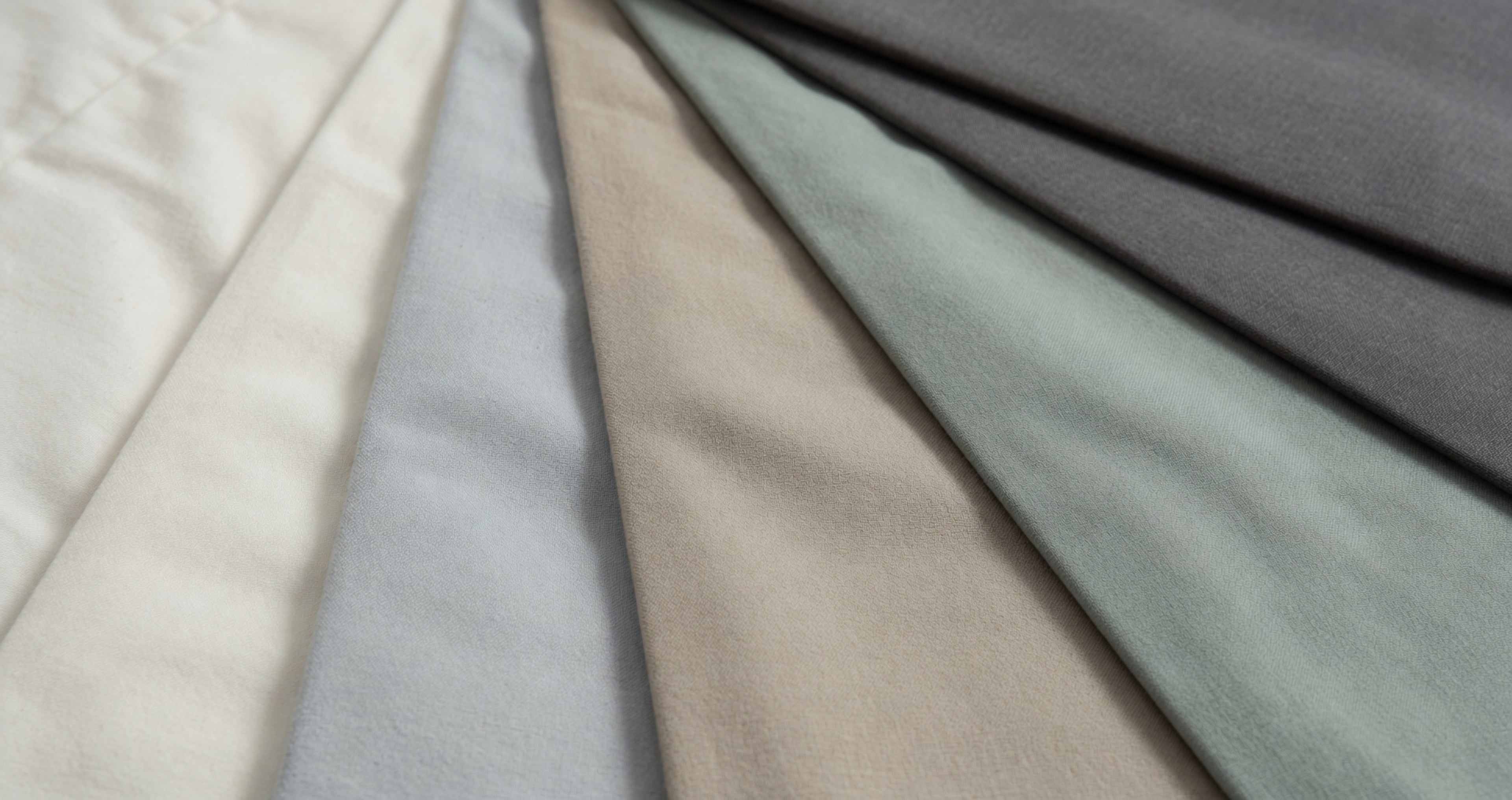Collection of fabric swatches in various neutral colors.