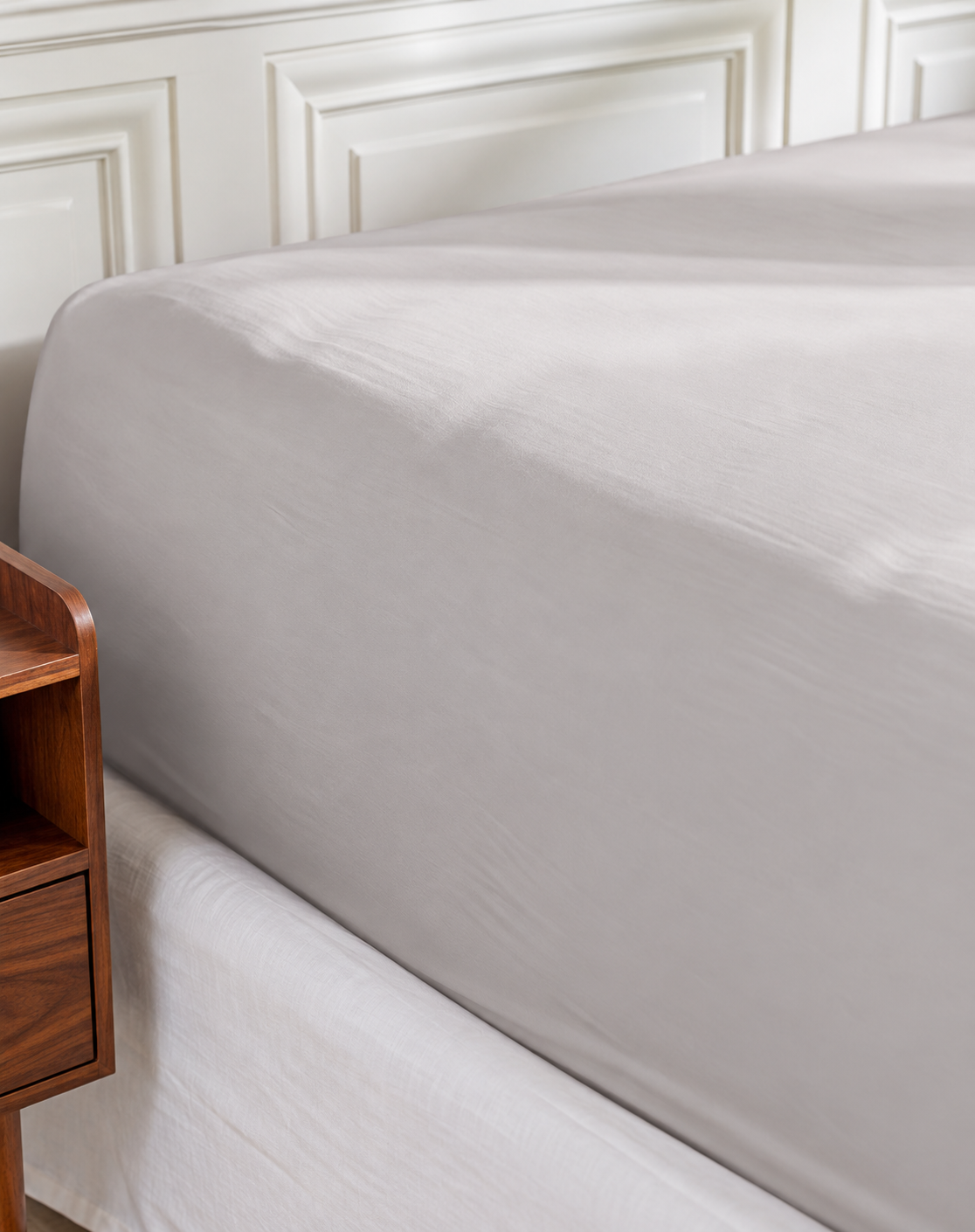 Plumelle Earth Fitted Sheet in Warm Grey on a made bed